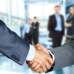 Website Design business associates shaking hands in office